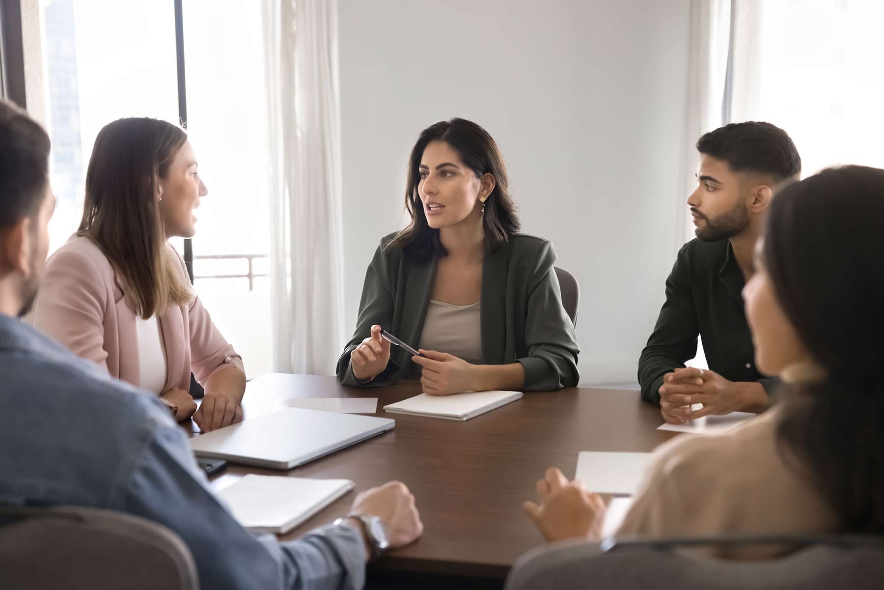 Female lawyer discussing class action lawsuit with clients Female lawyer discussing class action lawsuit with clients
