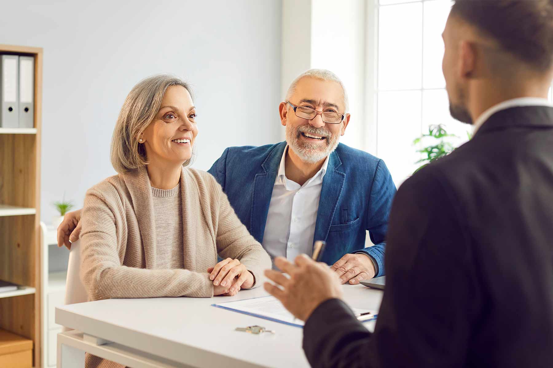 A senior couple consulting with an attorney about a living trust A senior couple consulting with an attorney about a living trust